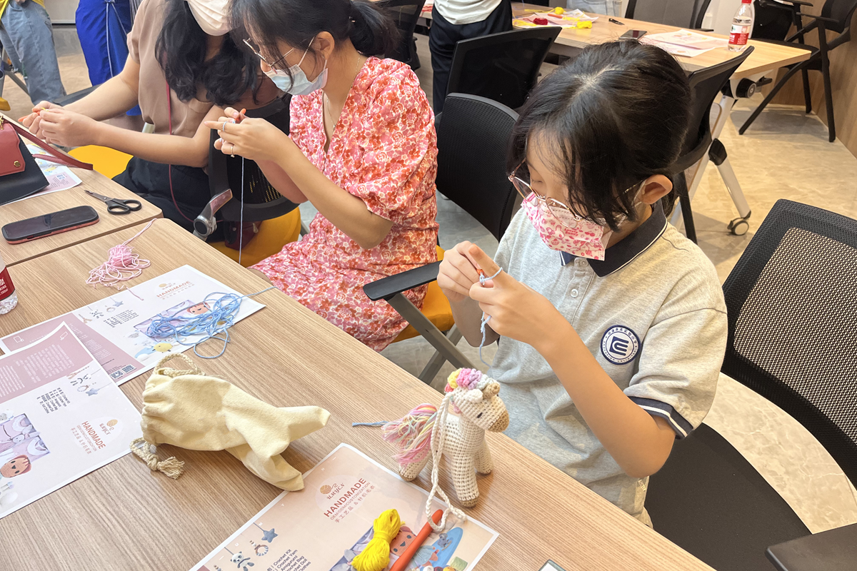 Person learning to crochet with a beginner's kit